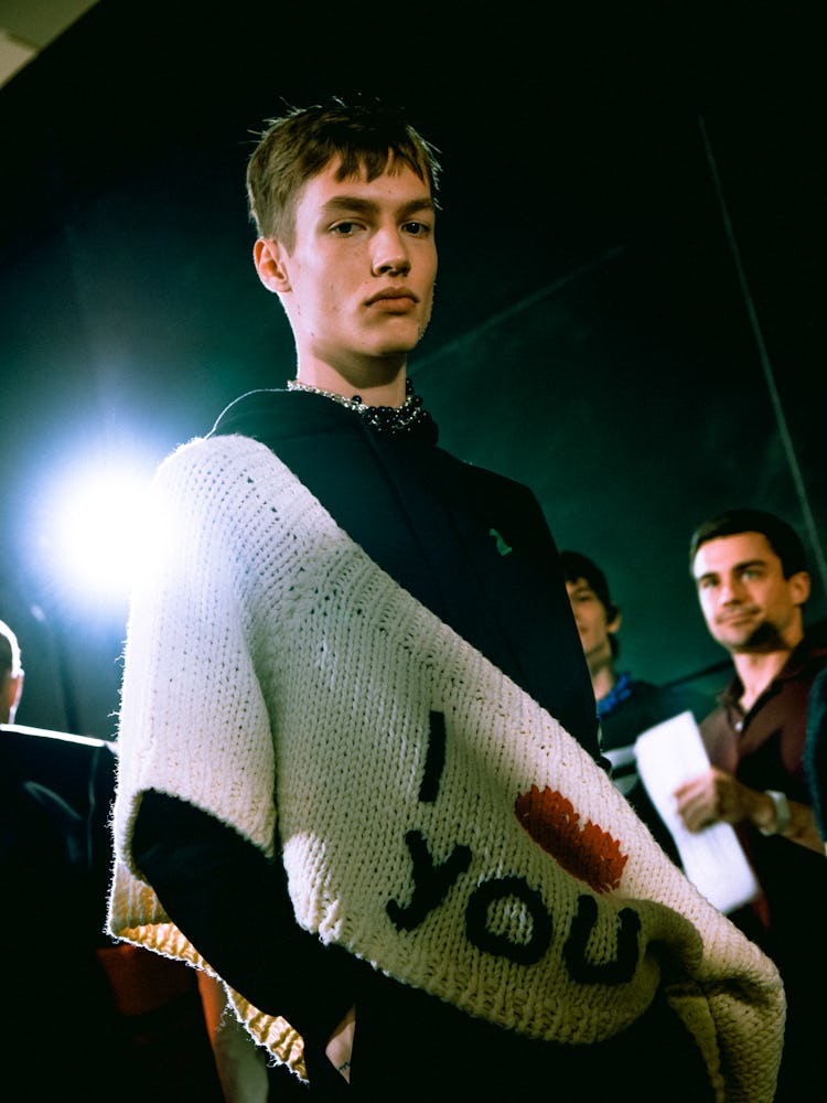 A model wearing Raf Simons' knit reading ' I love you.'
