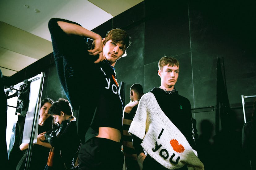Two boys posing in black and white sweaters with "I love you" text