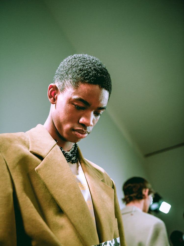 A model in a beige coat from Raf Simons' Fall 2017 collection