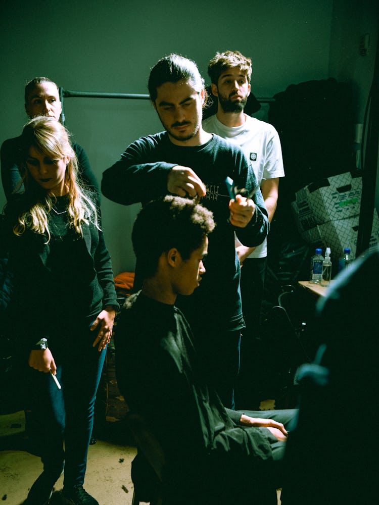 A model getting his hair trimmed backstage before the presentation of Raf Simons A/W ’17 Collection.