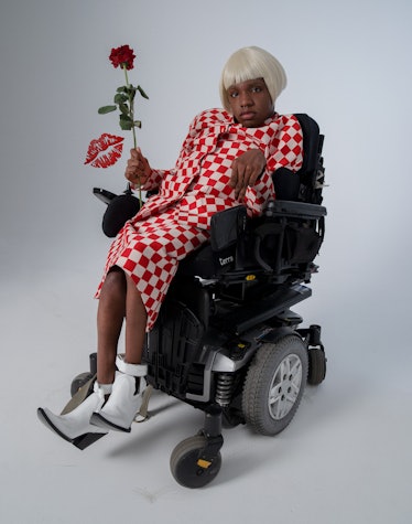 A model in a wheelchair in a red-white check jacket and skirt as an inspiration for Valentine's Day