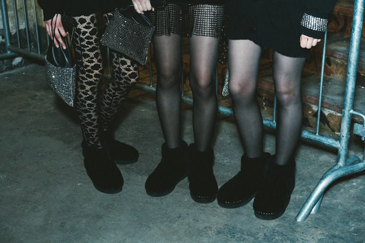 A close-up shot of three model's legs wearing tights and black boots at the Alexander Wang Fall 2017...