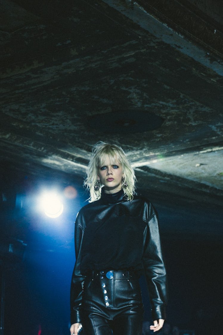 A short-haired blonde model in a black leather top and pants at the Alexander Wang Fall 2017 show