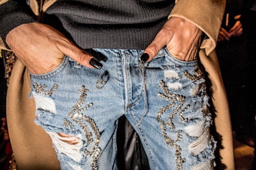 A male model with nail art, wearing distressed jeans at Philipp Plein’s Fall 2017 fashion show durin...