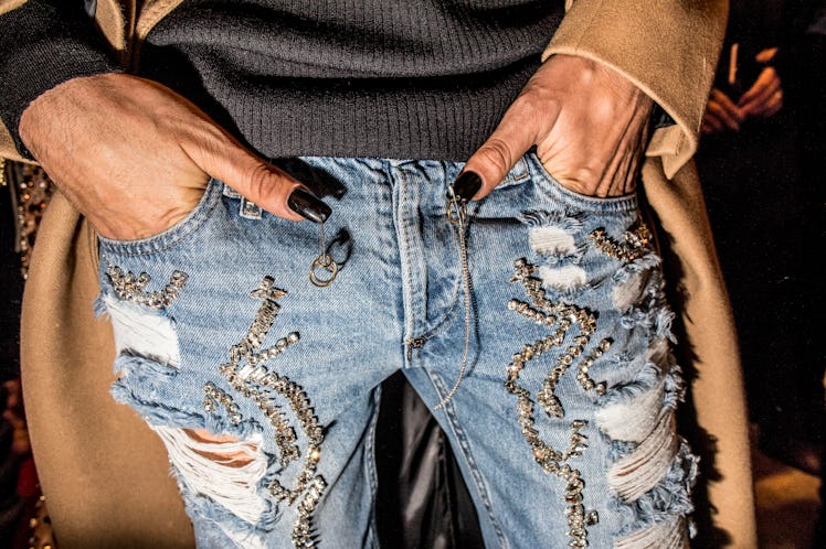 A male model with nail art, wearing distressed jeans at Philipp Plein’s Fall 2017 fashion show durin...