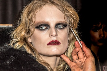 Hanne Gaby getting her makeup fixed before hitting the runway for Philipp Plein’s Fall 2017 fashion ...