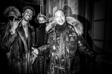 Jeremy Meeks wearing a parka standing with other models backstage at Philipp Plein’s Fall 2017 fashi...
