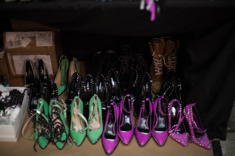 Green, purple and purple studded heels all places in rows one behind another backstage at the Zadig ...