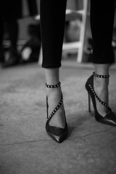 A closeup of a model's feet in studded heels with straps by Zadig & Voltaire 