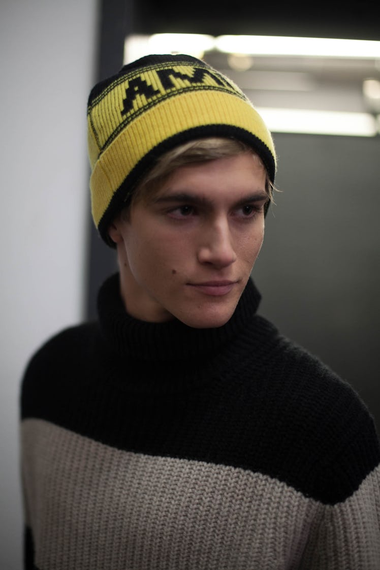 Presley Gerber in a yellow beanie and black and grey turtleneck backstage at the Zadig & Voltaire sh...