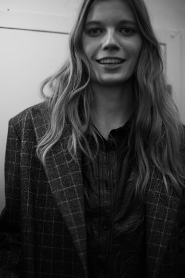 A model in a checkered blazer smiling at the camera backstage at the Zadig & Voltaire Fall 2017 show...