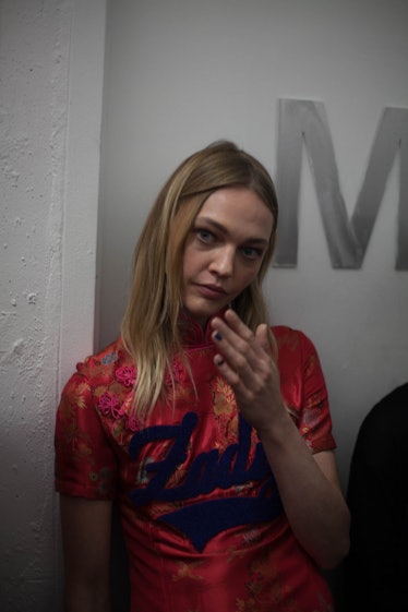 A model in a maroon floral top with "Zadig" on it backstage at the Zadig & Voltaire Fall 2017 show 