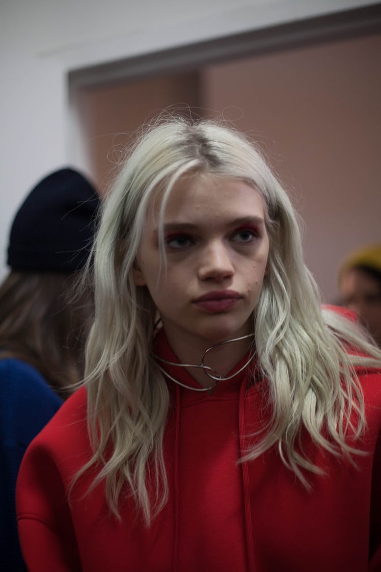 Daphne Groeneveld in a red jacket and metal necklace looking to the side backstage at the Zadig & Vo...