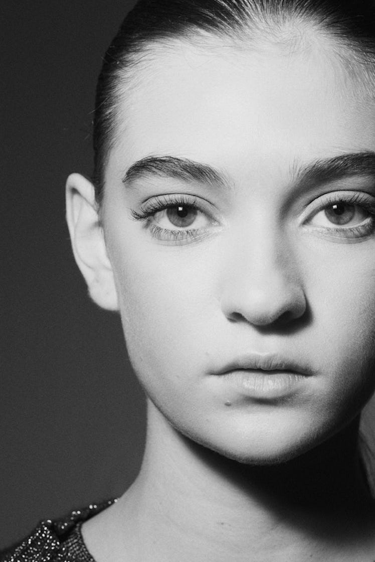 A close-up portrait of a model backstage at Oscar de la Renta Fall 2017