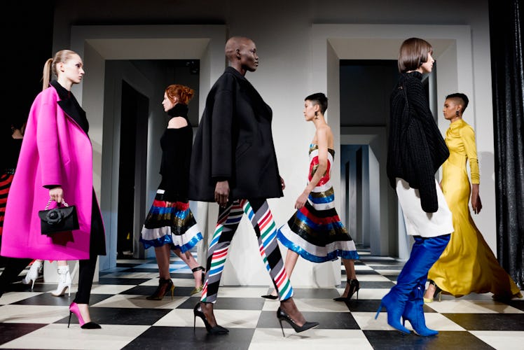 Six models wearing different suits and dresses in black, pink, blue and orange at Oscar de la Renta ...