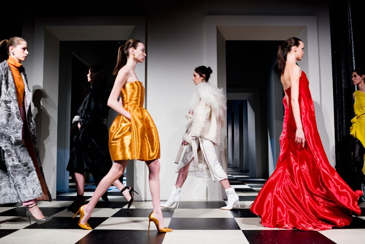 Six models sporting different dresses in red, orange and white at Oscar de la Renta Fall 2017