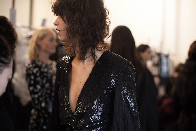 A brunette woman wearing a black sequin blazer 