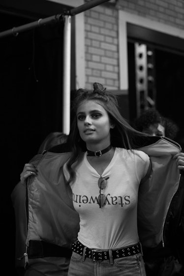 Taylor Hill in a white shirt with the text 'stayweird' and a double top knot