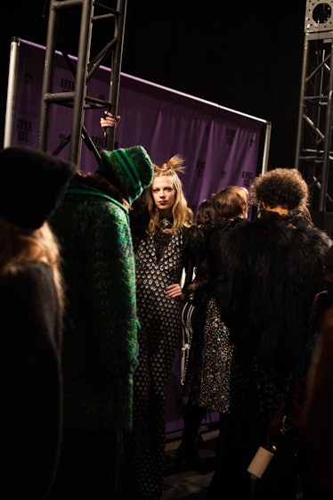 A group of models waking and standing backstage at Anna Sui Fall 2017