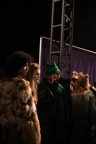 A group of models standing and posing backstage at Anna Sui Fall 2017