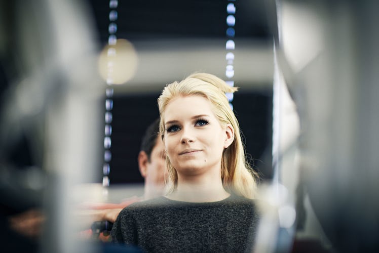 Lottie Moss sitting and looking herself in the mirror