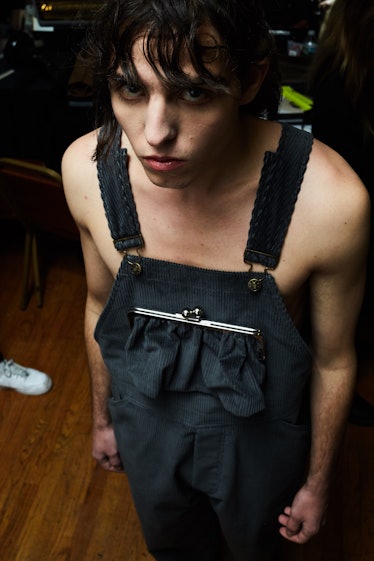 A model posing in a black working overall