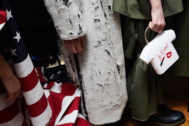 Three models that are wearing green, white, and American flag inspired dresses standing next to each...