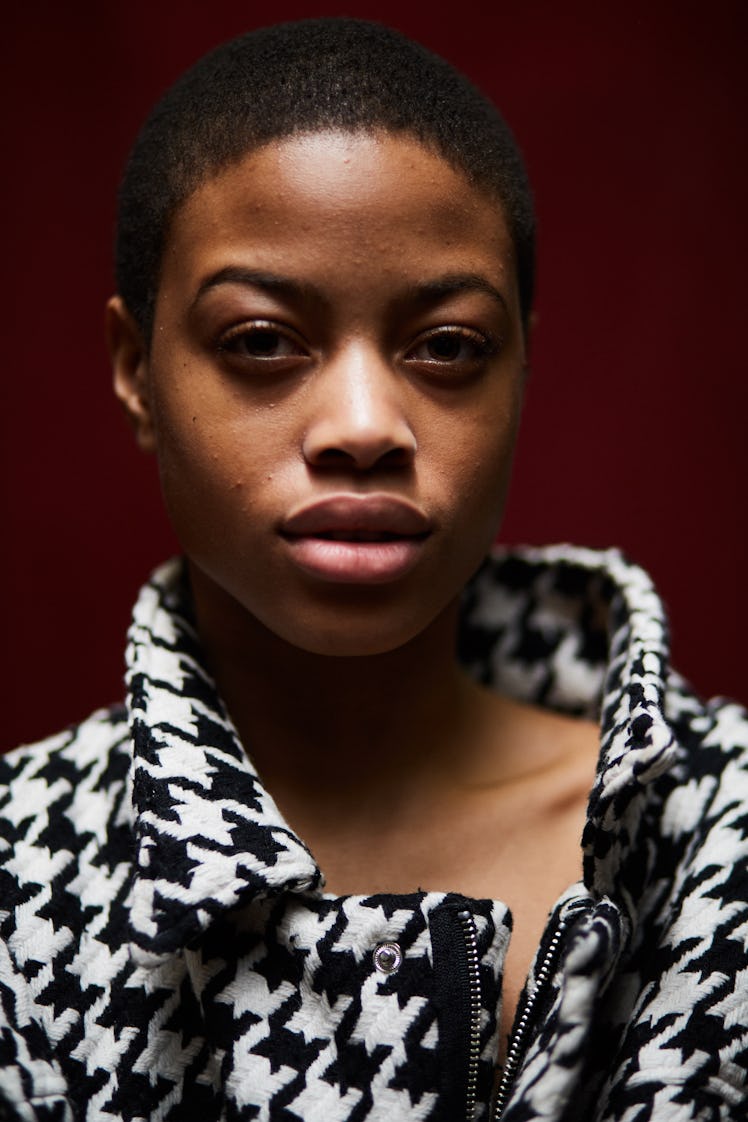 A model posing while wearing a black and white jacket