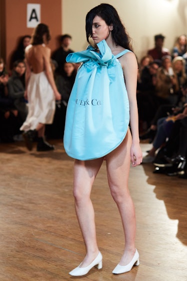 A female model walking in a bib-shaped light blue dress at the Vaquera Debut Show at New York Fashio...