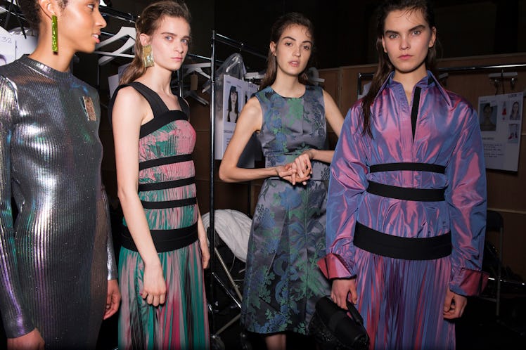 Four models in metallic, purple and green outfits at the Christopher Kane Fall 2017 show