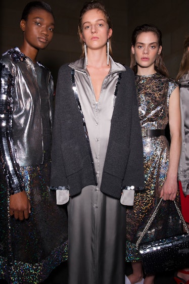A model in a silver dress a model in a grey dress and a model in a sequin dress at the Christopher K...