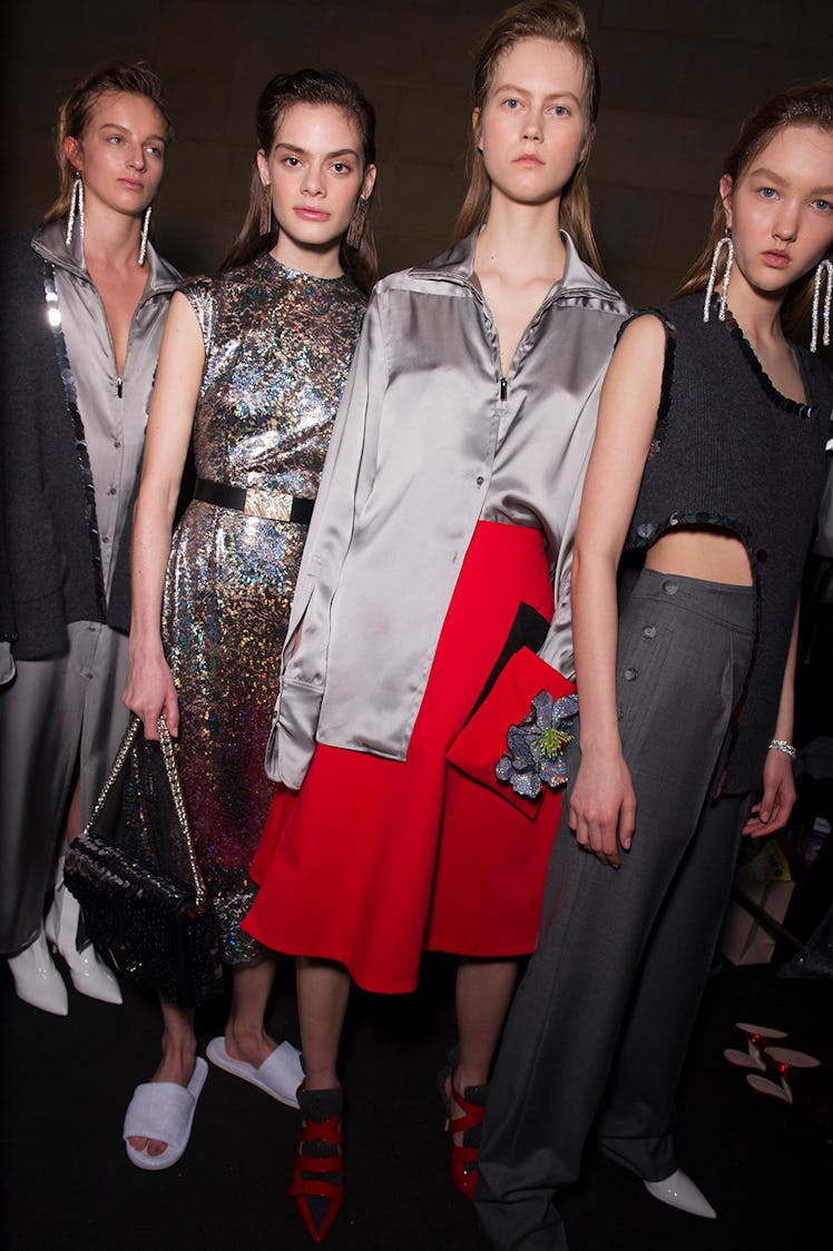 Four models in grey, silver and red metallic outfits at the Christopher Kane Fall 2017 show