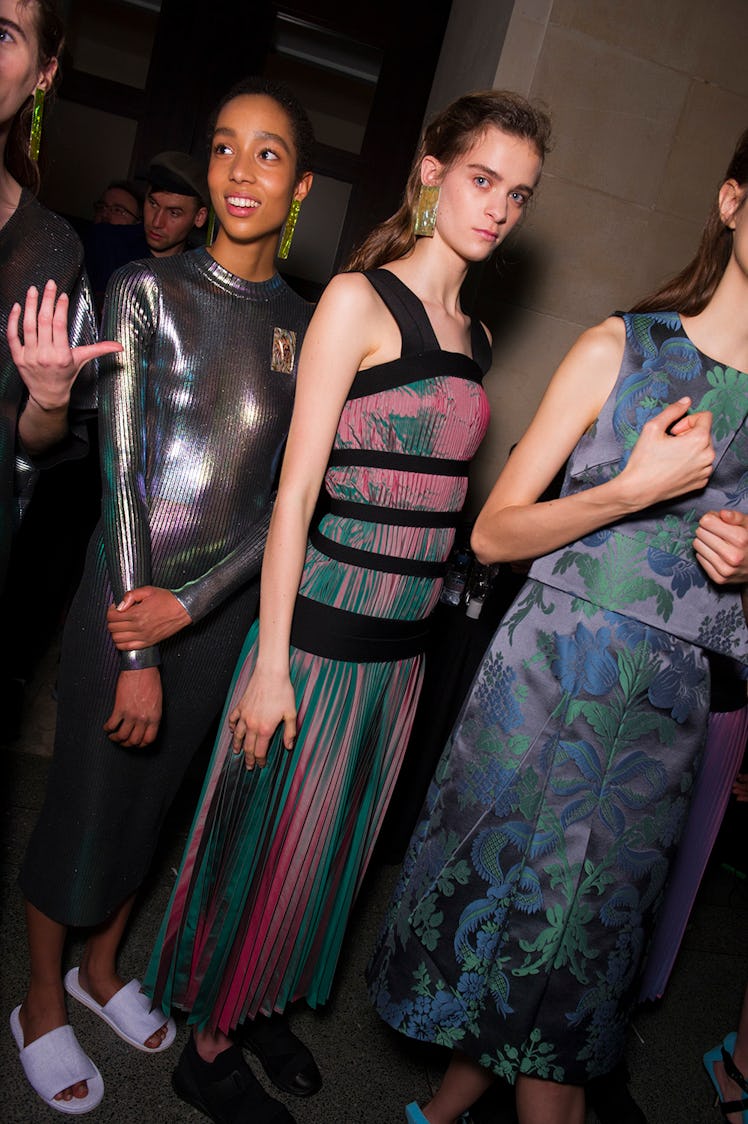 A model in a silver dress, a model in a pink/green dress and a model in a floral dress at the Christ...