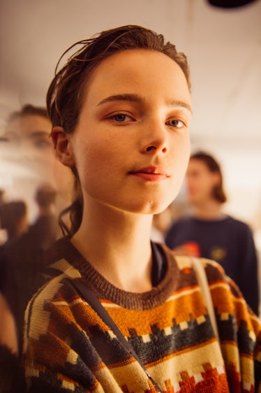 A brunette girl wearing a brown pullover at the backstage at Burberry Fall 2017 show
