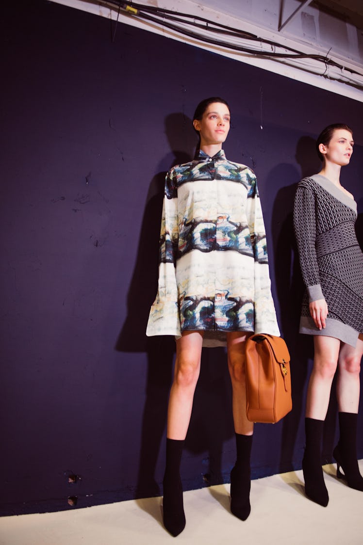 Two female models posing in black and white mini dresses at the backstage at Burberry Fall 2017 show