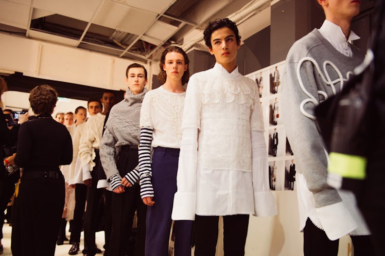 Male and female models standing in a queue at the backstage at Burberry Fall 2017 show