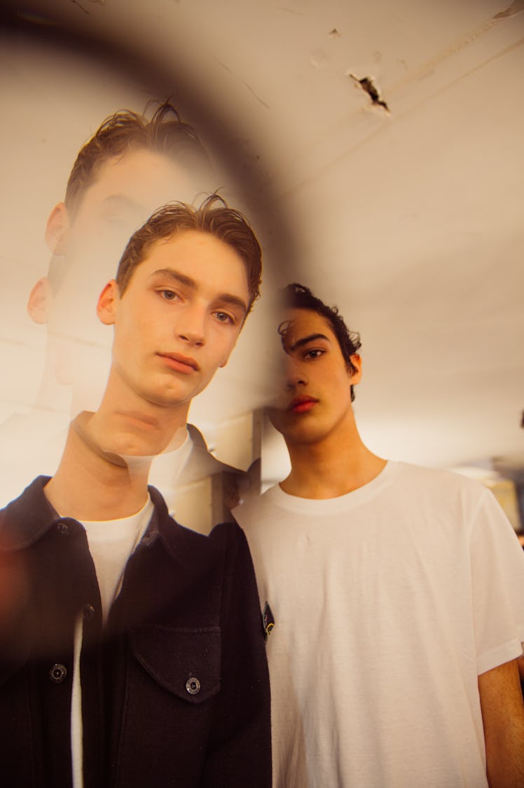 Two boys in white and black shirts posing for a photo