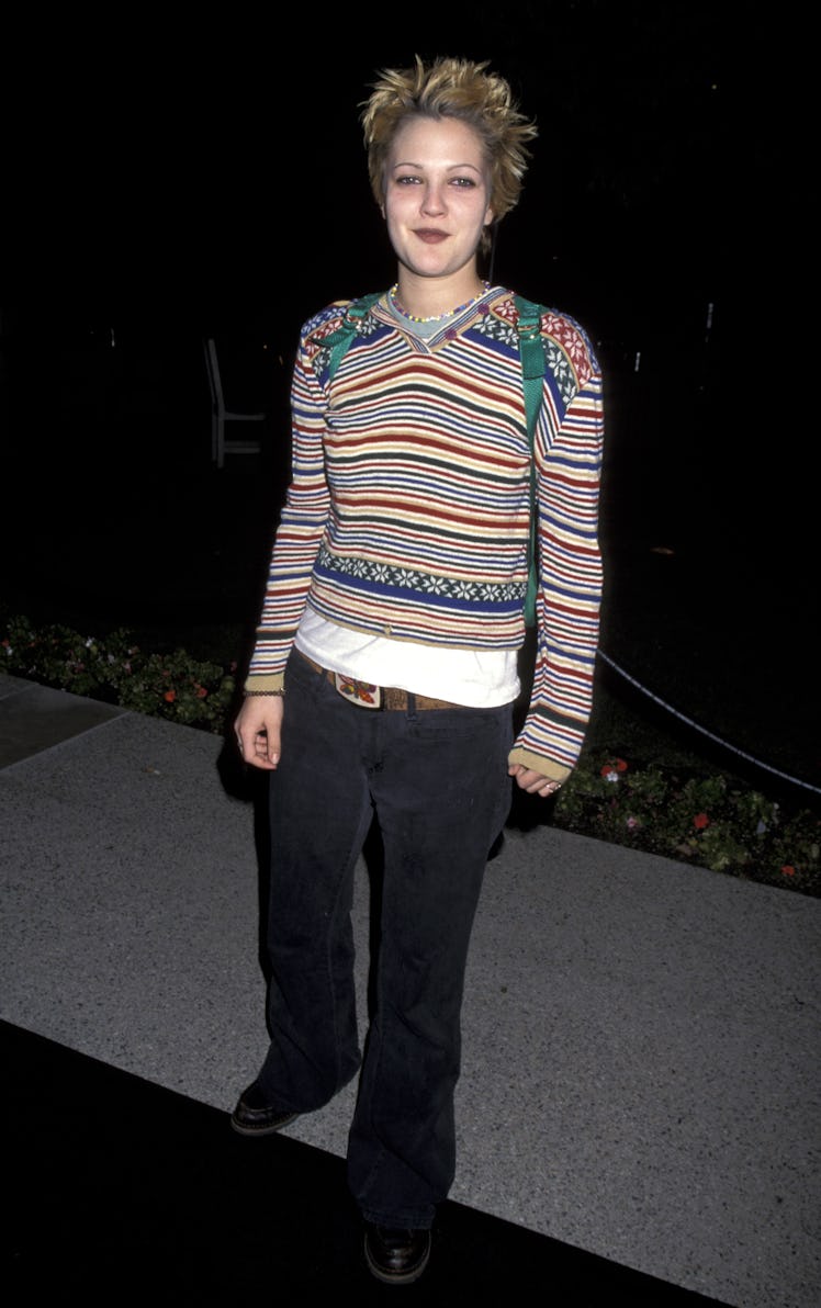 Drew Barrymore posing in a striped sweater