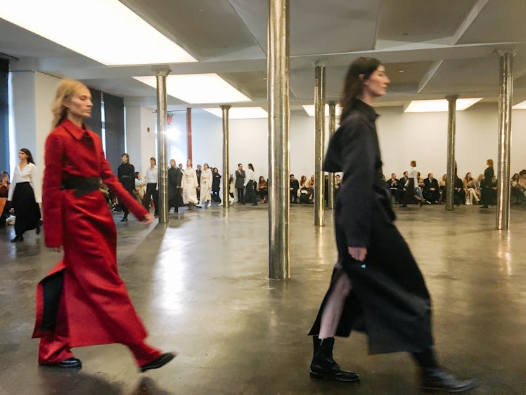 Two women walking while wearing black and red dresses