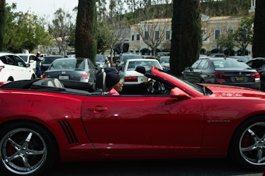 A woman driving a red cabriolet in Calabasas