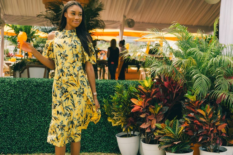 A woman in a yellow floral dress at Veuve Clicquot’s Third Annual Carnaval party in Miami.