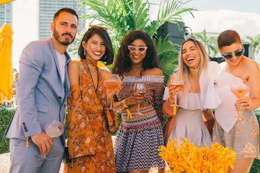 A group of friends posing for a photo at Veuve Clicquot’s Third Annual Carnaval party in Miami.