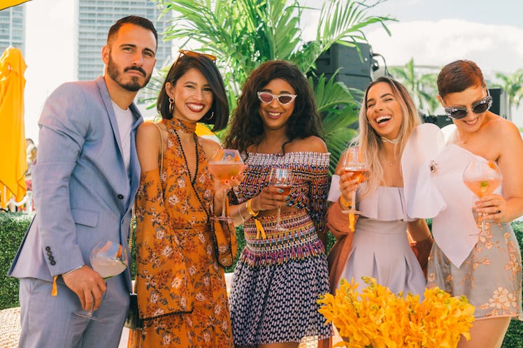 A group of friends posing for a photo at Veuve Clicquot’s Third Annual Carnaval party in Miami.