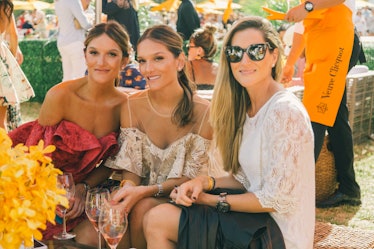 Three women posing for a photo at Veuve Clicquot’s Third Annual Carnaval party in Miami.