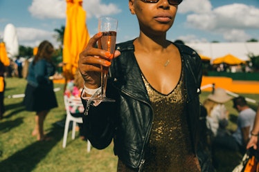 A woman holding her drink at Veuve Clicquot’s Third Annual Carnaval party in Miami.