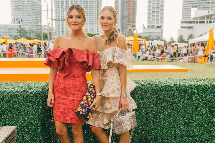 Two women in off-shoulders, frilled dresses at Veuve Clicquot’s Third Annual Carnaval party in Miami...