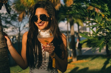 A guest holding her drink at Veuve Clicquot’s Third Annual Carnaval party in Miami.