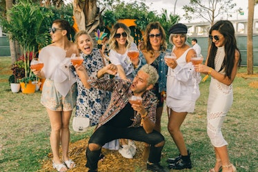 A group of friends posing for a photo during Veuve Clicquot’s Third Annual Carnaval party in Miami.