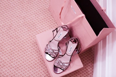 Pink rhinestone embellished sandals on a pink shoe box