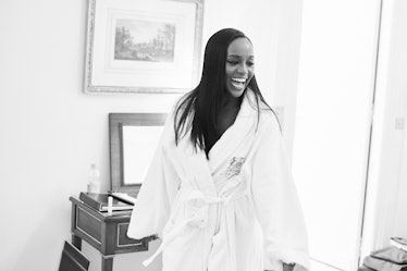 Aja Naomi King smiling while wearing a bath robe before her first Miu Miu show